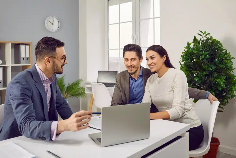 Portrait,Of,Happy,Caucasian,Couple,Sitting,With,A,Business,Broker