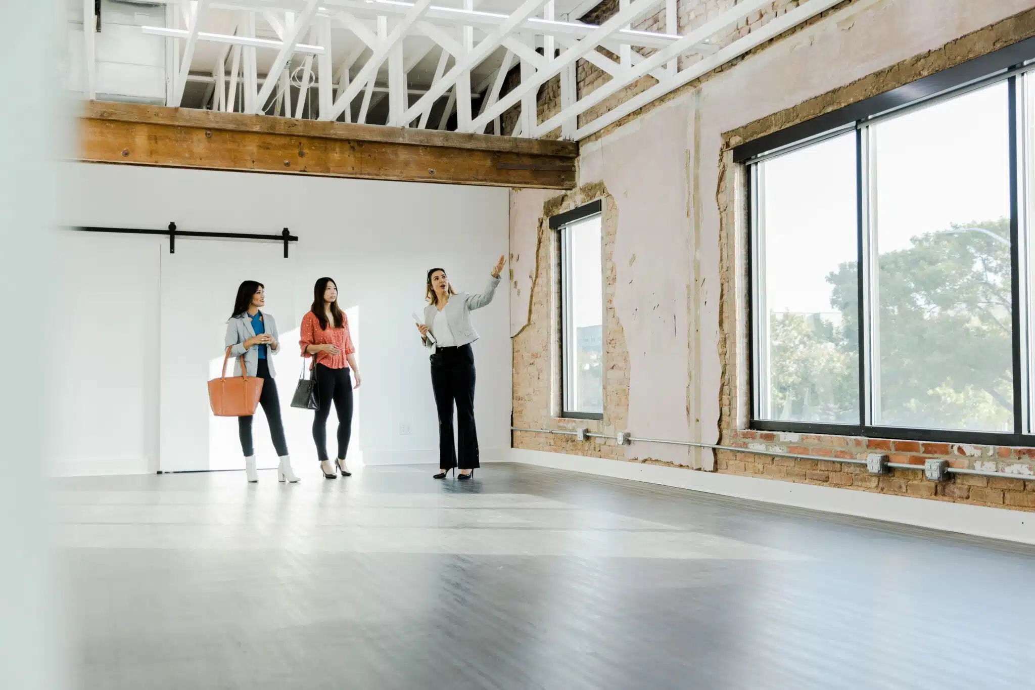 Real estate agent gestures while explaining office features to customers