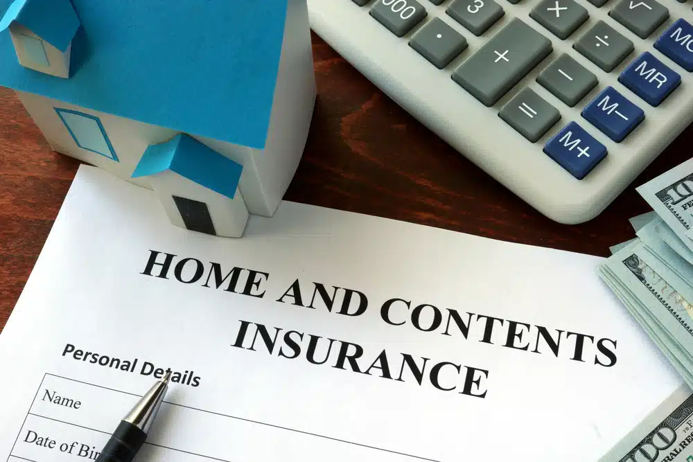 Home,And,Contents,Insurance,Form,And,Dollars,On,The,Table.