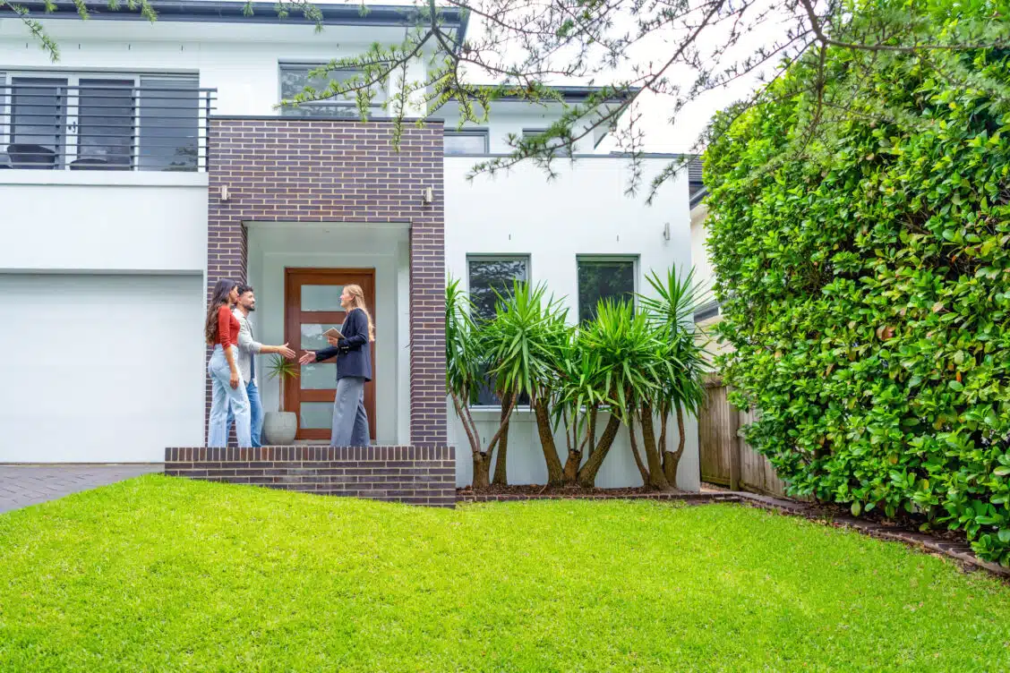 Real estate agent showing a couple a new house.
